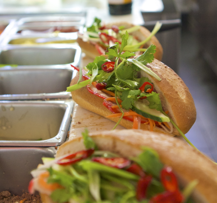 Three banh mi being prepared. Those fresh and vibrant colours can only be a good thing!