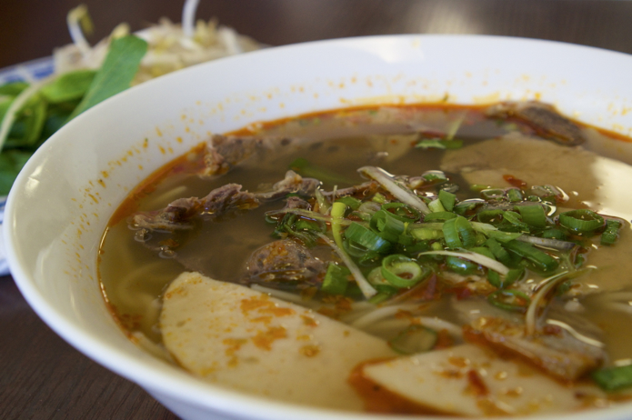 My spicy bun bo hue. Slices of beef and pork in a spicy broth with noodles.