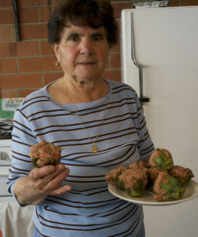 Nonna wielding the raw artichokes. She is explaining to me what the next step is. 