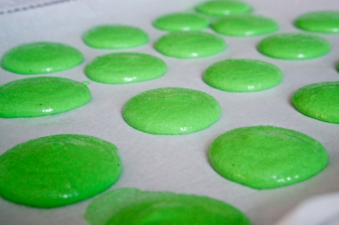 Green macarons resting before going into the oven