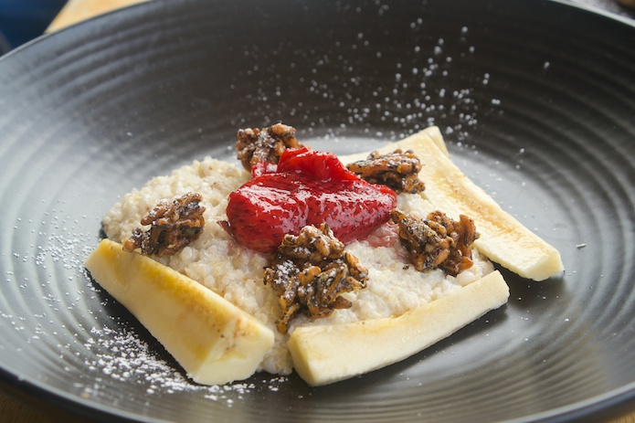 Buckwheat and quinoa porridge, macerated strawberries, back puffed rice, banana and coconut
